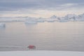 Expeditions - Zodiac with tourists cruises through Antarctic iceberg landscape at Portal Point