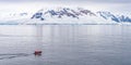 Expeditions - Zodiac with tourists cruises through Antarctic iceberg landscape at Portal Point