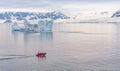 Expeditions - Zodiac with tourists cruises through Antarctic iceberg landscape at Portal Point