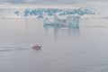 Expeditions - Zodiac with tourists cruises through Antarctic iceberg landscape at Portal Point