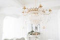 Expensive interior. Large electric chandelier made of transparent glass beads. White ceiling decorated with stucco Royalty Free Stock Photo