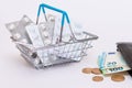 Pills and Capsules in a Shopping Basket and Black Wallet with Euro Money