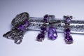 Expensive set of silver women`s jewelry with violet stones - ring, pendant and earrings. , copy space