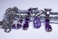 Expensive set of silver women`s jewelry with violet stones - ring, pendant and earrings. , copy space