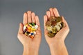 Expensive treatment concept with piles of cash money and pharmaceutical drugs in woman hands
