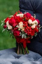 Expensive, trendy wedding bouquet of roses in marsala and red colors standing on chair. Bridal details and decor with flowers Royalty Free Stock Photo