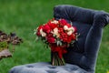 Expensive, trendy wedding bouquet of roses in marsala and red colors standing on chair. Bridal details and decor with flowers Royalty Free Stock Photo