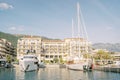 Expensive yachts are moored off the shore of the Regent Hotel. Porto, Montenegro