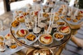 Expensively decorated table with tartlets and ice-cream in golden utensils Royalty Free Stock Photo