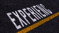 Experienc text written and yellow line on the road in middle of the asphalt road, for business planning strategies and challenges