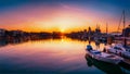 a breath-taking view of sunset on a pier with small boat Royalty Free Stock Photo