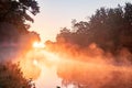 Mystical Sunset Mist Over Canal: Golden Rays Illuminating Tranquility