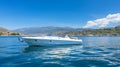 A White and Blue Boat Sailing on the Open Sea Royalty Free Stock Photo