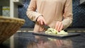 Experience housewife cuts vegetables cooking dish for lunch