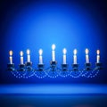 Celebration of Hanukkah with a lit menorah representing the Jewish holiday and religious tradition