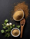 Coriander seed powder on a black background.