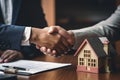 Real estate agent shaking hands with customer after signing contract to buy a house. Ai generative