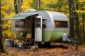 Experience tranquil camping. cozy trailer nestled amidst serene woods of a picturesque campground