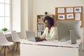 Experienced african american businesswoman typing on laptop in office