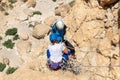 Experienced athletes on Israel Independence Day check equipment before rappel in mountains of Judean Desert, near Khatsatson