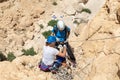 Experienced athletes on Israel Independence Day check equipment before rappel in mountains of Judean Desert, near Khatsatson