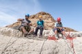 Experienced athletes rest before the descent with the equipment for snapping in the mountains of the Judean Desert near the