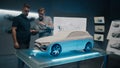 Experienced automotive designers discuss the design infront of the car sculpture