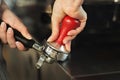 Closeup of barmen hand brewing espresso in professional coffee machine