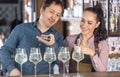Experienced bartender teaches apprentice the art of mixology, preparing cocktails on a bar
