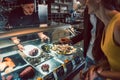 Experienced chef choosing raw seafood from the freezer for two customers