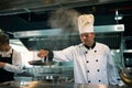 Experienced chef is cooking in a large kitchen