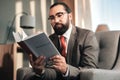 Experienced concentrated bearded lawyer reading administrative law