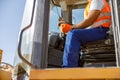 Experienced construction worker using truck at factory Royalty Free Stock Photo