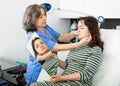 Experienced cosmetology doctor examines face a young woman patient