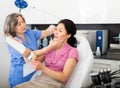 Experienced cosmetology doctor examines a young woman patient before the procedure Royalty Free Stock Photo