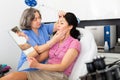 Experienced cosmetology doctor examines a young woman patient before the procedure