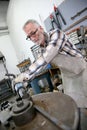 Experienced craftsman working on iron Royalty Free Stock Photo