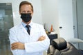 Qualified dental specialist posing while wearing a mask
