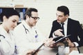 Experienced doctor advises businessman in medical office. Consultation with attending physician.