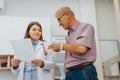 Experienced Doctor Analyzing X-Ray Results with Elderly Patient Royalty Free Stock Photo