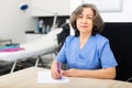 Experienced doctor writes important notes while sitting at workdesk in the cabinet Royalty Free Stock Photo