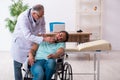 Experienced doctor and young male patient in wheel-chair