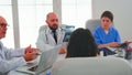 Experienced elderly doctors in hospital meeting room working together