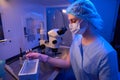 Experienced embryologist is performing cryogenic preservation of embryos in lab