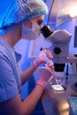 Experienced embryologist preparing specimen for microscopic examination