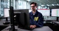 Experienced FBI Agent Examines Multiple Monitors Royalty Free Stock Photo