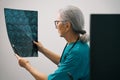 Experienced female diagnostician examines an MRI scan of the brain