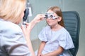 Experienced female optometrist carrying out dynamic retinoscopy on child Royalty Free Stock Photo