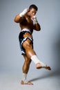 An experienced fighter kickboxer with a raised foot. Royalty Free Stock Photo