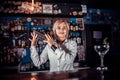 Experienced girl bartending demonstrates his skills over the counter while standing near the bar counter in bar Royalty Free Stock Photo